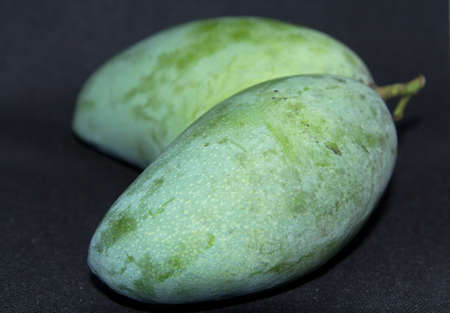 Twin Mangos-Naturally create a farmer's product with unusual shapes of nature exotic and different on-black background,naturally unusual as seen.の写真素材