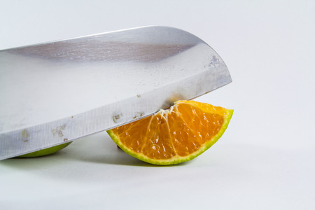 A knife to cut out half orangeの写真素材