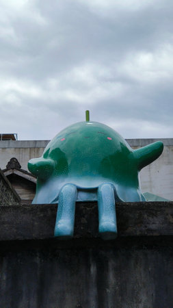 Green piggy bank on the roof of a building in Taiwan.の写真素材