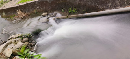 Waterfall in the park. Panoramic view. Long exposure.