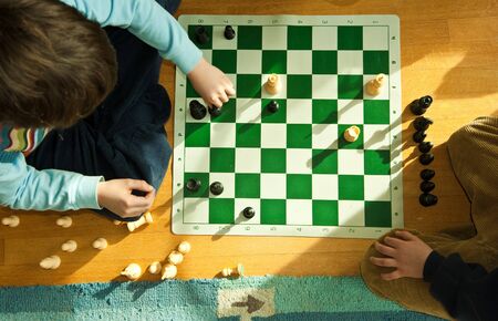 young boy playing chessの写真素材