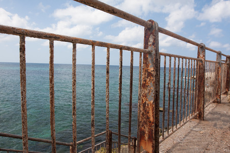 Rusty fence near the oceanの写真素材