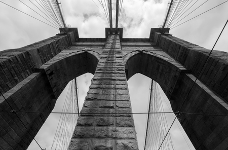 Brooklyn Bridge, bottom up view cloudy dayの写真素材