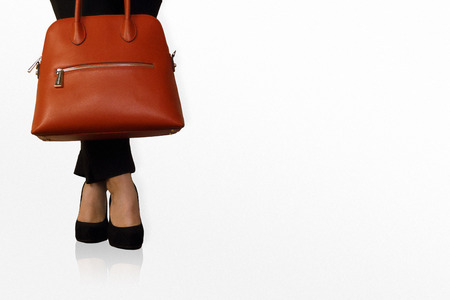 elegant woman waiting with heels and bagの写真素材