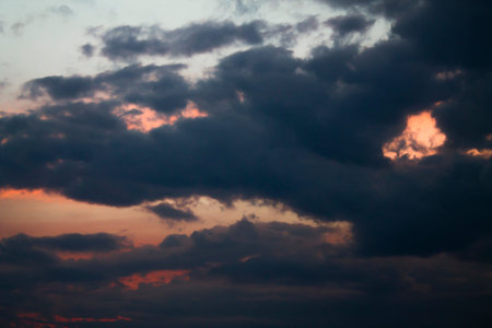 Sunset with dark clouds, in orange and purple shades