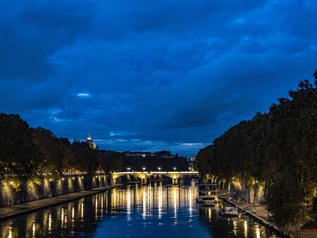 night on bridge Giuseppe Mazzini and the Fiume Tevere river in Rome Italyの写真素材