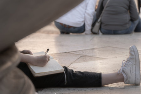 Young girl writing into her notebook