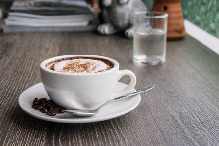 Coffee cup and coffee beans on wood table ,warm and good smellの写真素材
