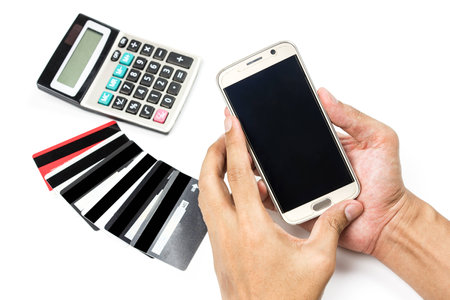 Online payment Concept. Man using credit card and Office desk table with clockの写真素材