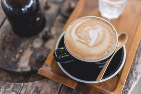 Coffee cup and coffee beans on wood table ,warm and good smellの写真素材
