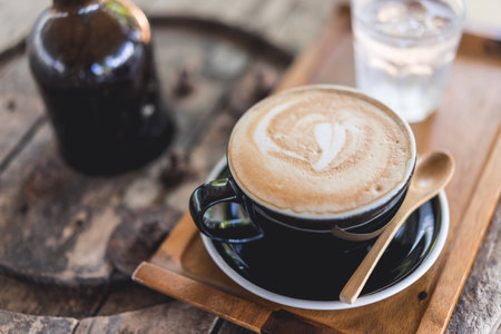 Coffee cup and coffee beans on wood table ,warm and good smellの写真素材