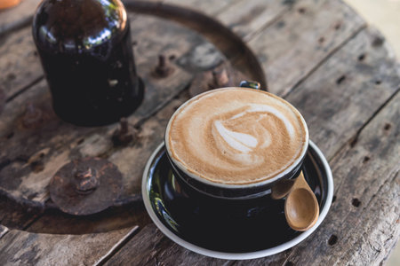 Coffee cup and coffee beans on wood table ,warm and good smellの写真素材