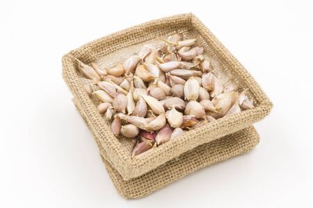 Garlic in small burlap sackの写真素材