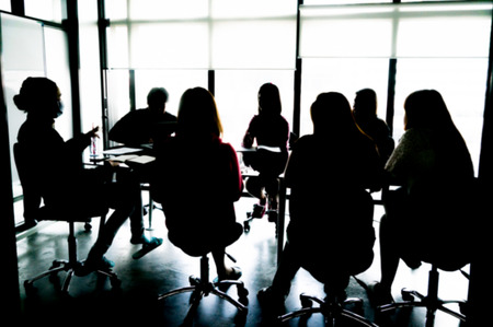Silhouettes of Business People Having Board Meeting. Blur or Defocus image.の写真素材