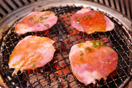 Pork grill on hot coals. This kind of food is a Korean or Japanese BBQ style.の写真素材