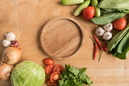 Top view of Fresh vegetables with wooden tray  on wooden table background.の写真素材