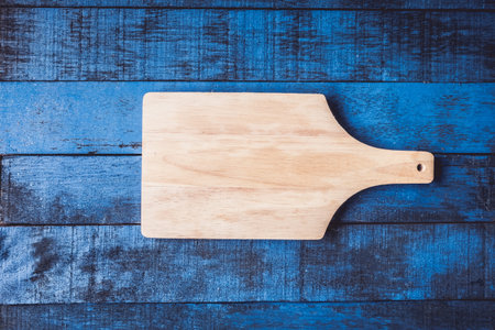 Top view of  wooden tray on bule wooden table background.