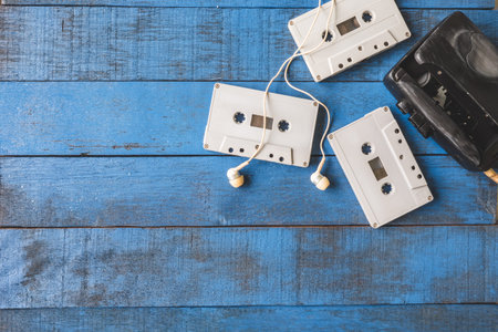 Top view of Cassette player with audio tape on blue wooden table background, Free space for text