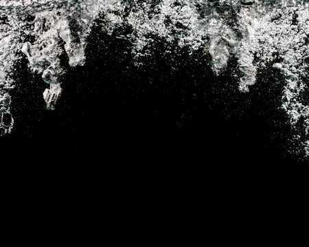 Bubbles water isolated on black backgroundの写真素材