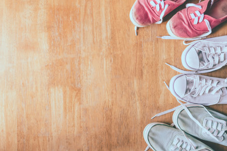 Top view of Colorful sneakers on the wooden table background.