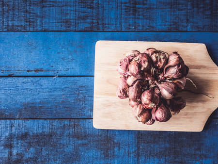 Top view of  Red onion on blue wooden table background.