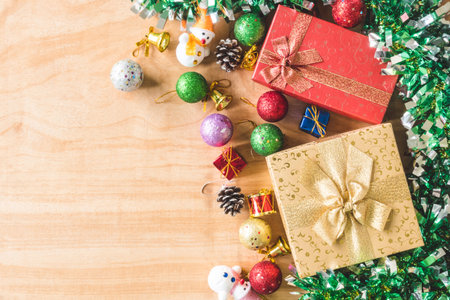 Top view of Gift boxes with Christmas decoration on wooden table background