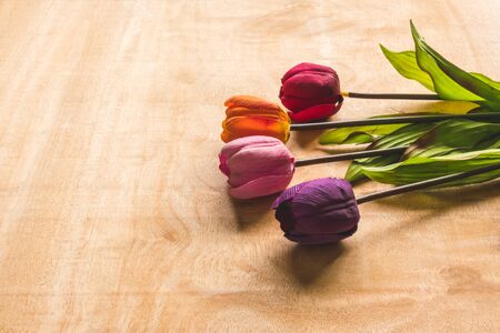 Top view of Colorful Tulip flowers on wooden table background, free space for textの写真素材