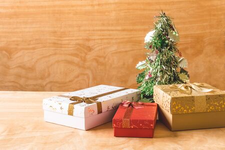 Gift boxes with Christmas decoration on wooden table background.の写真素材