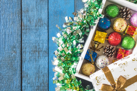 Top view of Gift box with Christmas decoration on wooden table background.