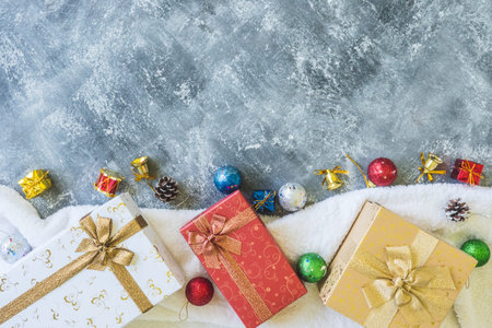 Top view of Gift boxes with Christmas decoration on gray grunge background.