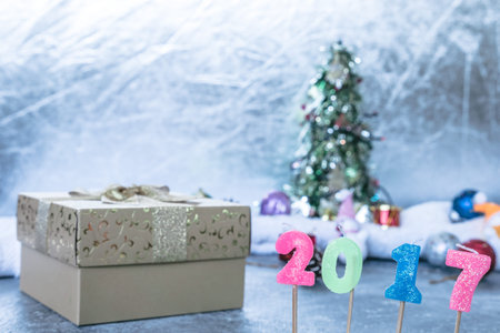 Number 2017 with gift box on Christmas decoration background.
