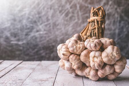 Bunch of garlic on wooden tableの写真素材