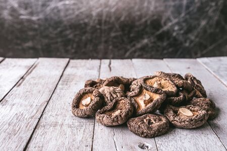 Dry Shiitake mushrooms on wooden table.の写真素材