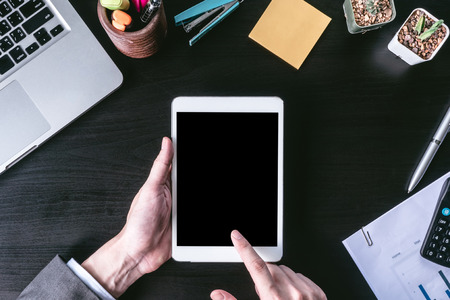 Top view of Businessman using tablet on the office desk.の写真素材