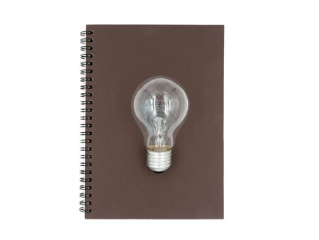 notebook with light bulb on the white backgroundの写真素材