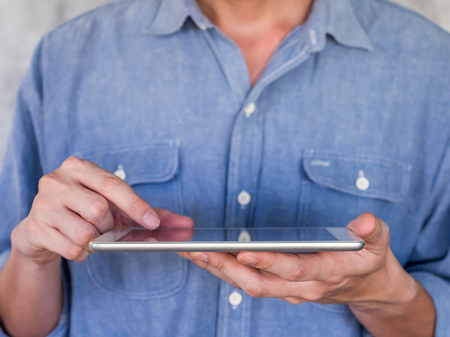 Close up of Casual man using a tablet, communication conceptの写真素材
