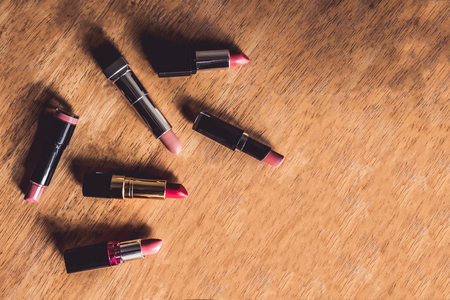 Top view of colorful lipsticks on the wooden table. Makeup and Beauty conceptの写真素材