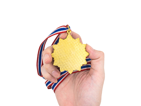 Hand holding Gold medal on white backgroundの写真素材