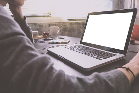 Close up of Casual young woman using a laptop with blank screen on the desk. Vintage toneの写真素材