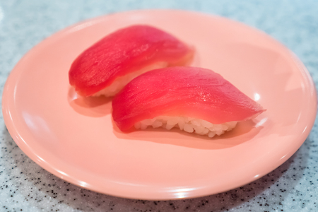 Tuna sushi - rice with fresh tuna on dish, japanese food (soft focus)の写真素材