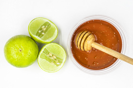 Honey and lemon on white background.の写真素材