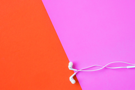 Earphones on colorful background. Free space for textの写真素材
