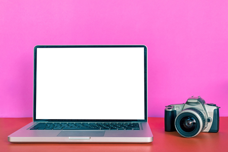 Modern laptop with blank screen, camera on colorful background.の写真素材