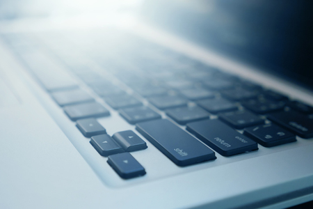 Close up of laptop keyboard with sunlight. selective focusの写真素材