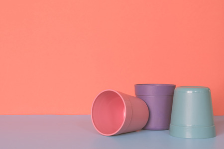 Three color plastic cup on pastel colors background.の写真素材