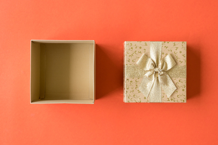 Top view of open gift box on orange backgroundの写真素材