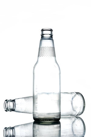 Empty colorless glass bottles on a white background.の写真素材