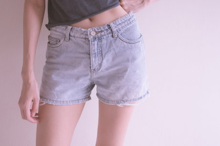 Photo of girl with blue jean shorts.