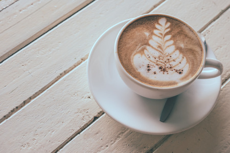 Cup of coffee on the wooden table, Vintage toneの写真素材