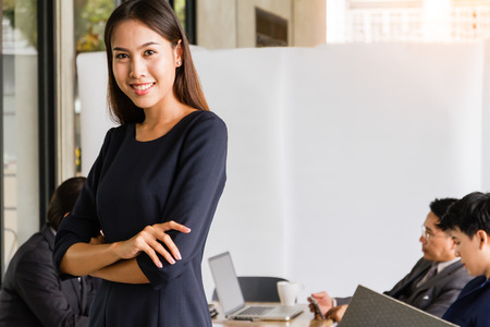 Portrait of happy asian businesswoman with her team at the office.の写真素材